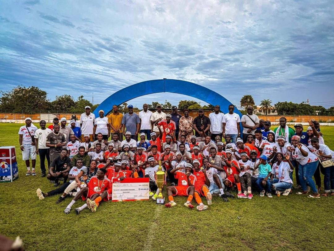 ASM Athletic players, staff and supporters celebrating together on the football pitch