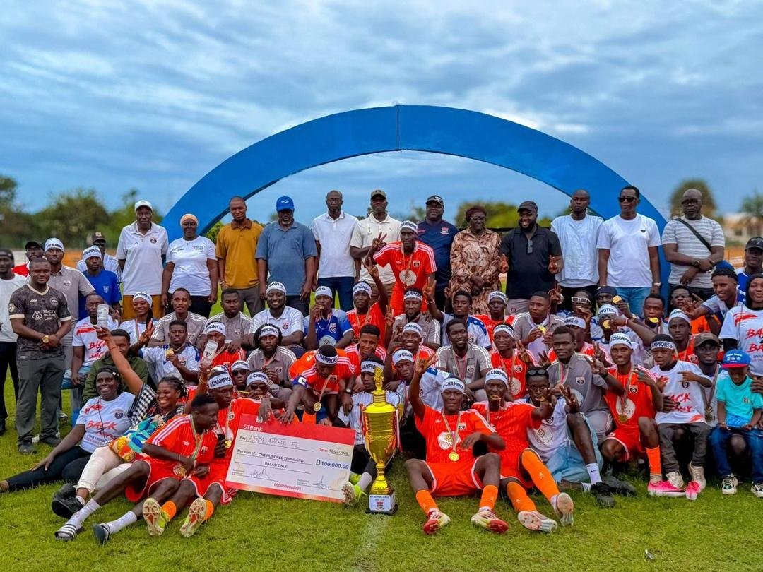 ASM Athletic players and supporters gathered around a trophy