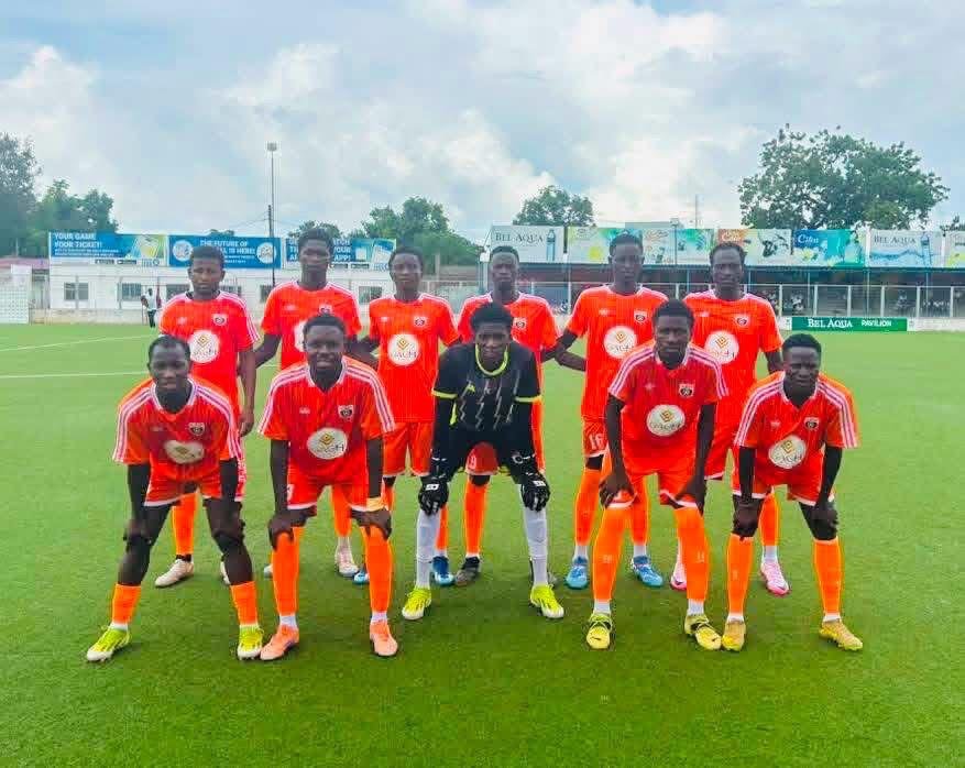 ASM Athletic football team lined up on the pitch in orange kits